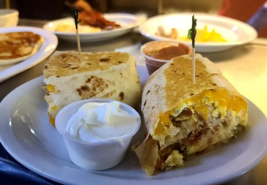 Breakfast Burrito - Ham, Sausage, onion, jalepeno, cheddar, gravy and hashbrowns rolled into a flour tortilla image